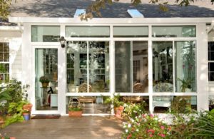 Sunroom with white color windows and glass door
