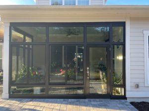 Sunroom with black frame installed in single family home.
